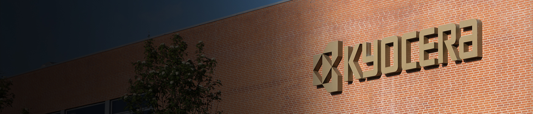 A close-up of the Kyocera logo on the Kyocera Unimerco building in Sunds