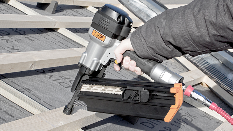A nail gun by the TJEP brand is in use on a roof