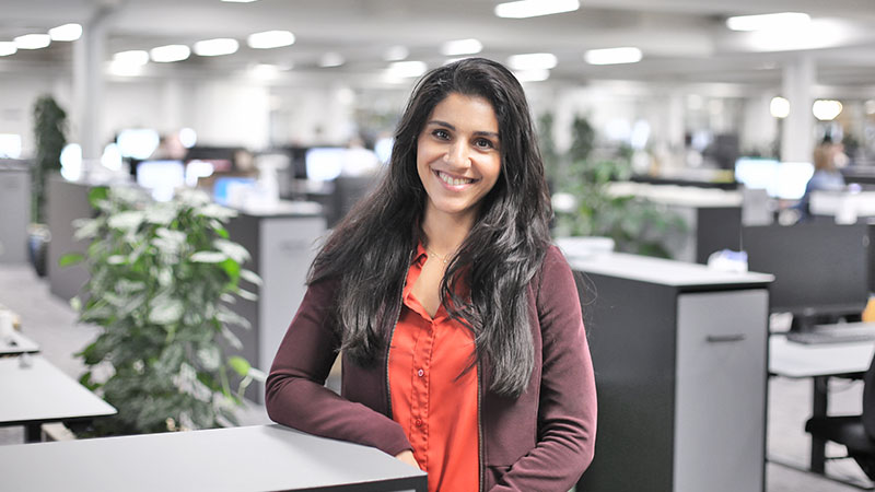 Colleague smiling in the middle of the office