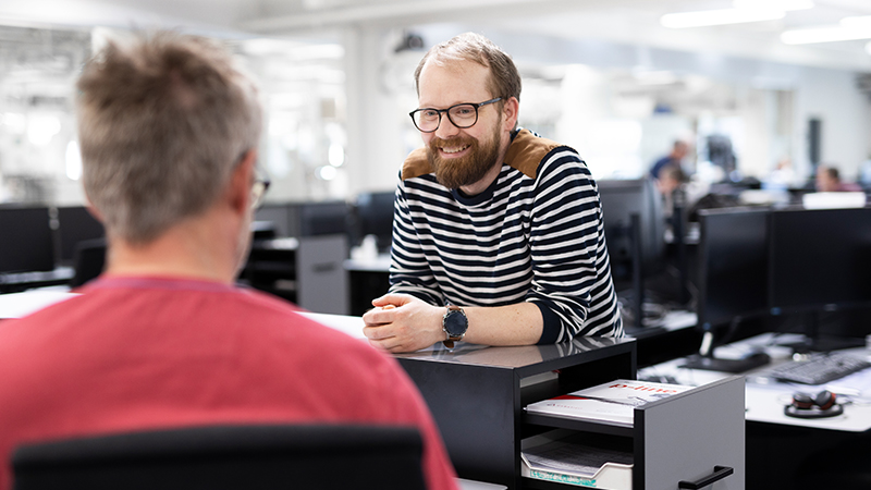 2 colleagues talking in the office area