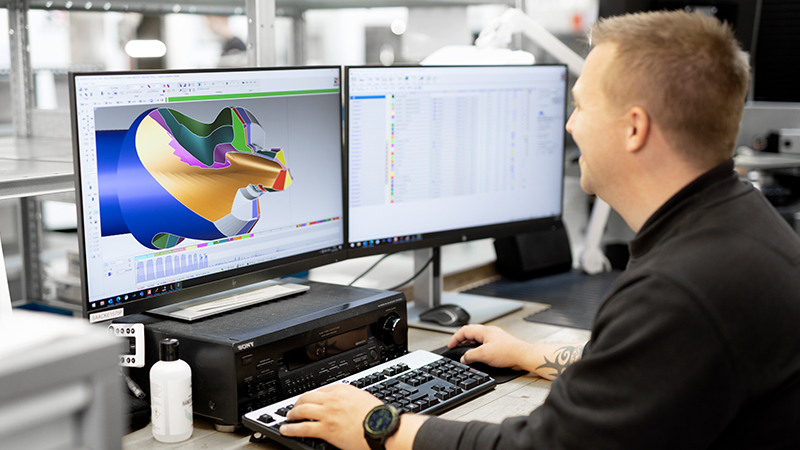 An industrial technician looking at a 3D model of a tool